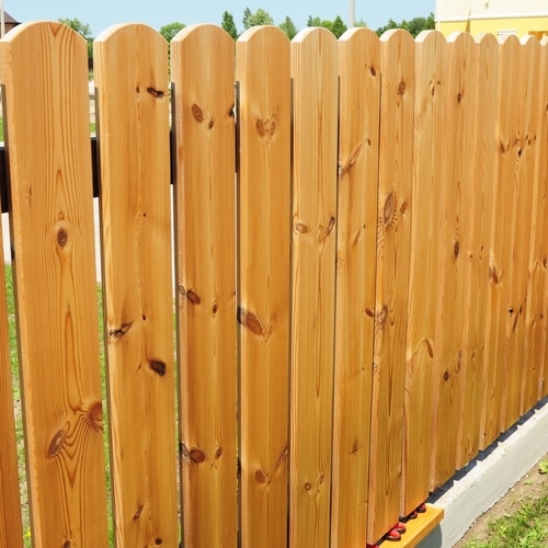 Light tan vertical wooden paneled fence